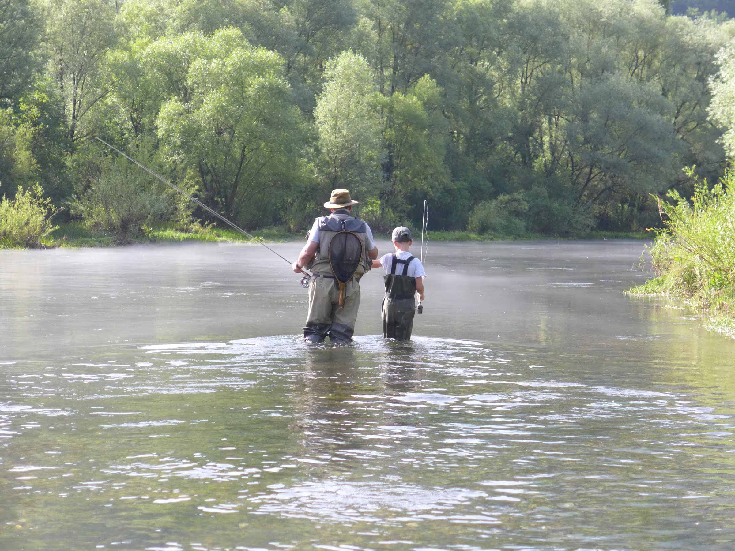Farther and Son fly fishing in river